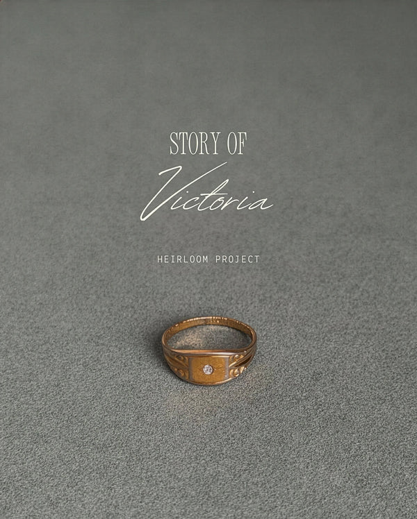 Ring on a textured gray surface with 'Story of Victoria Heirloom Project' text.