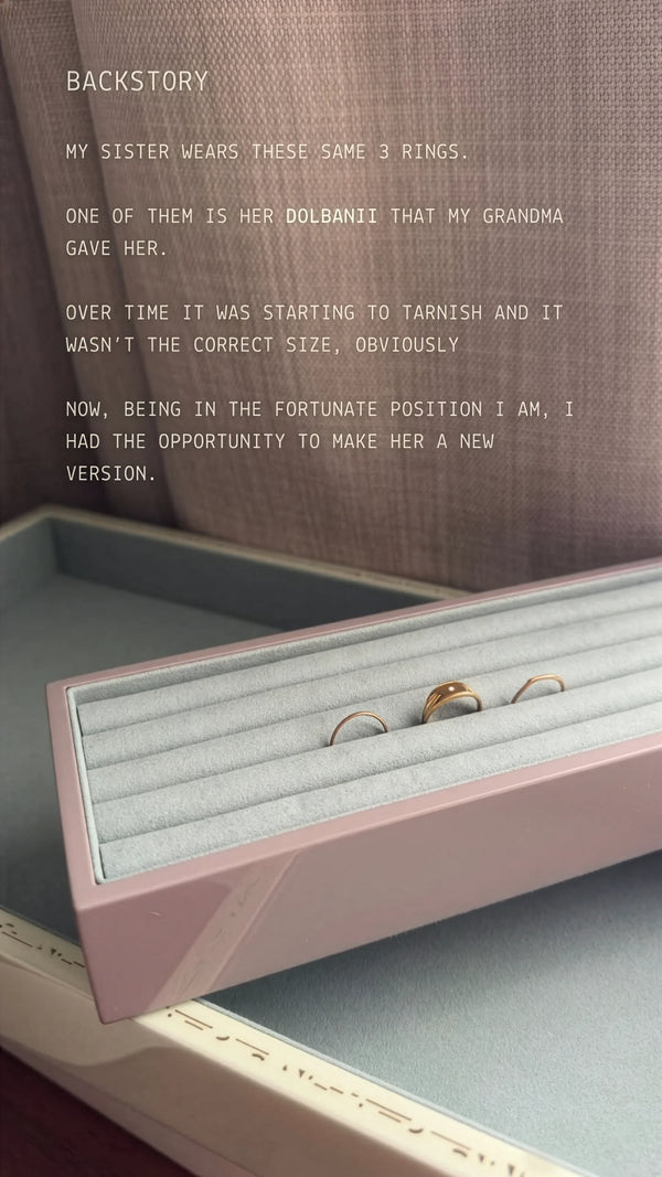 Open jewelry box with rings and text about a sister wearing Dolman rings.