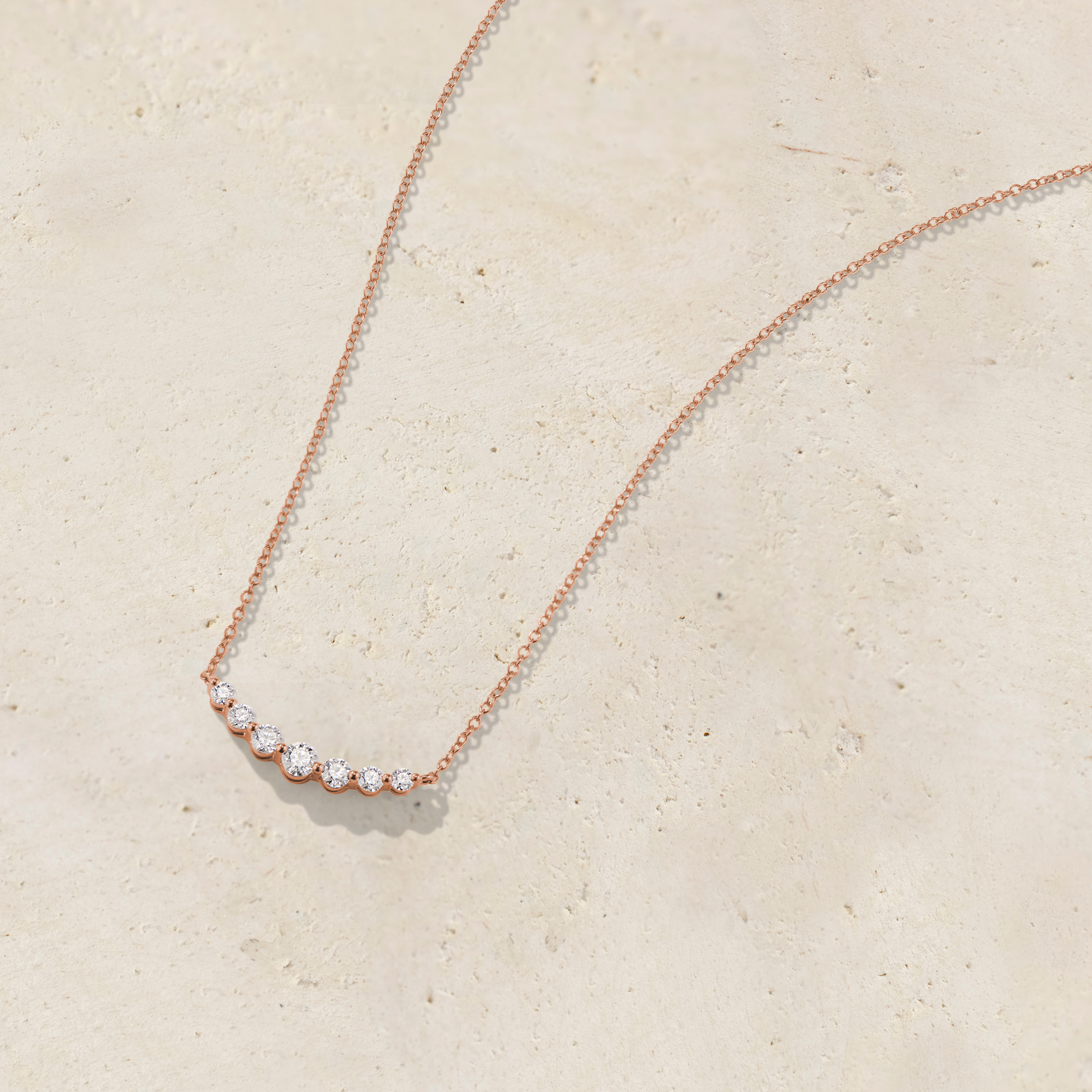 LHUNE 7 Diamond Graduated Necklace, front view of seven graduating round diamonds on slim cable chain