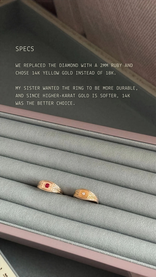 Two rings on a gray cushion in a jewelry box with text about ring specifications.