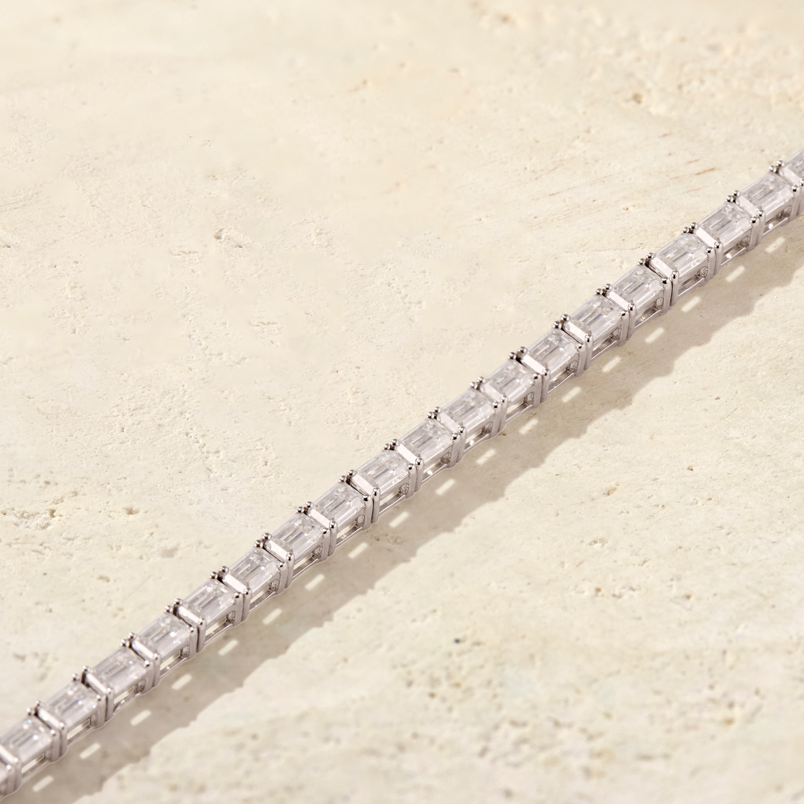 LHUNE Amara East-West Emerald-Cut Tennis Bracelet in white gold, diagonal close-up of east-west emerald-cut diamond prong setting