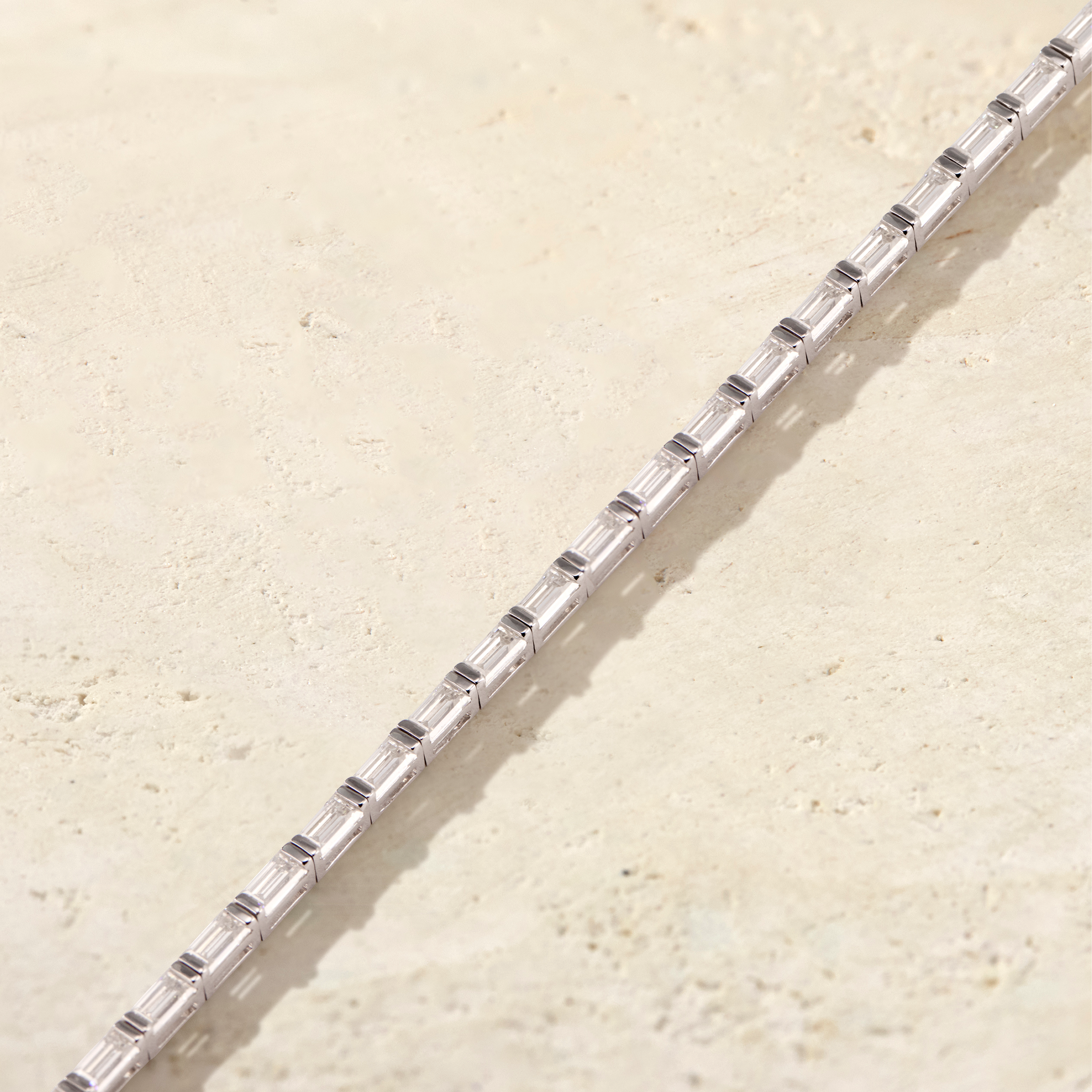 LHUNE Canella Baguette Tennis Bracelet in white gold, diagonal close-up of east-west baguette diamond channel setting