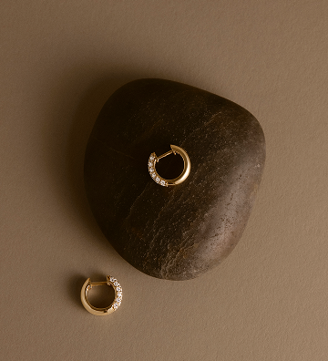 Brown Background with earring on top of stone